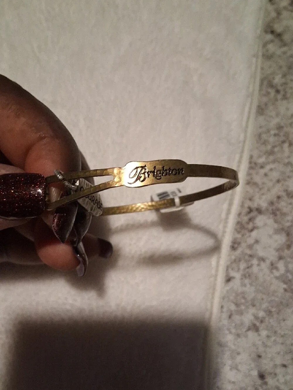 A.  Brighton Gold Tone Bangle with 'Courage' Charm